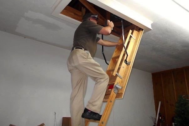 What are the warning signs of a dangerous attic pull-down ladder?