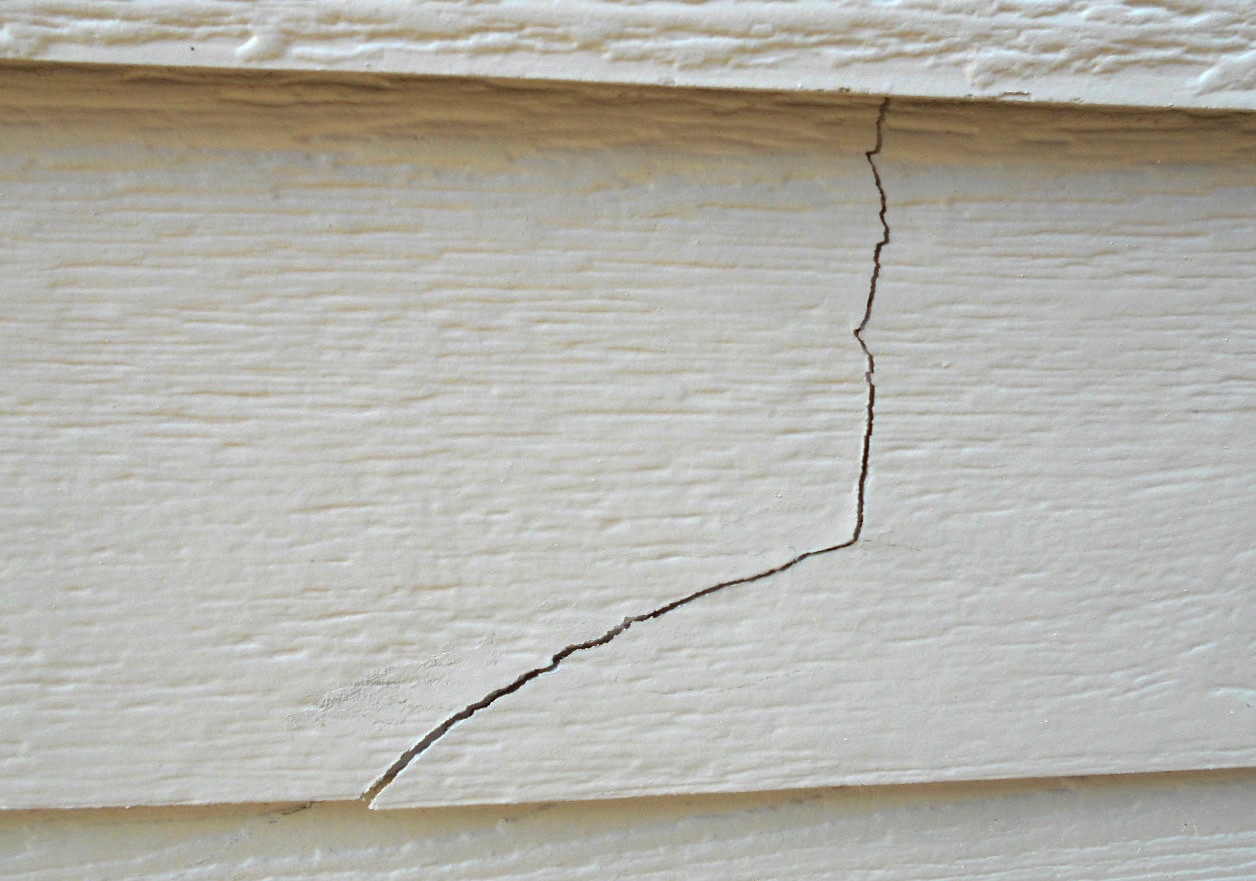 A close-up of cracked wooden siding. 