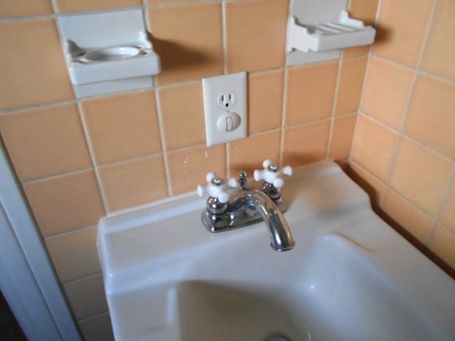 distance from bathroom sink for electric outlet