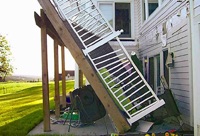 What is the most common cause of a wood deck collapse?