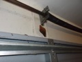 Is the wood anchor pad for a garage door rail and torsion spring supposed to be nailed or bolted to the wall?
