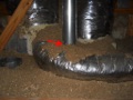 Why is insulation not allowed to touch around a gas flue in the attic even if the insulation is not flammable?