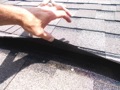 What would cause a new asphalt shingle roof to have loose tab adhesion (sealant strips)?