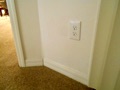 How long must a wall space be to require a receptacle outlet?