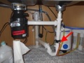 Where do you connect the drain line from a reverse osmosis system under a kitchen sink?