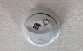 How close can a smoke detector be to an air conditioning/heating supply register (vent)?