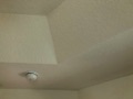 Where should a smoke detector be placed on a tray (coffered) ceiling?