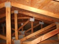 Is it legal to bore holes through roof trusses to install wiring?