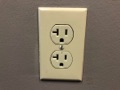 Why do some receptacle outlets have a T-shaped hole?