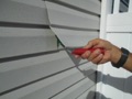 What is a vinyl siding zipper tool?